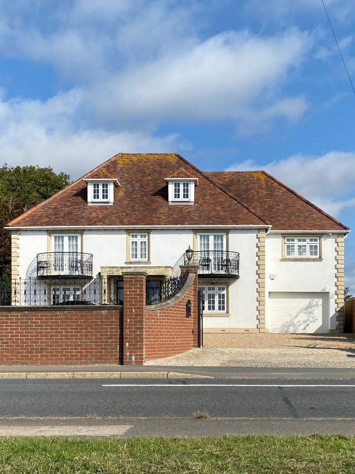 Charming facade of a modern residential house in Drayton, UK, under blue skies.